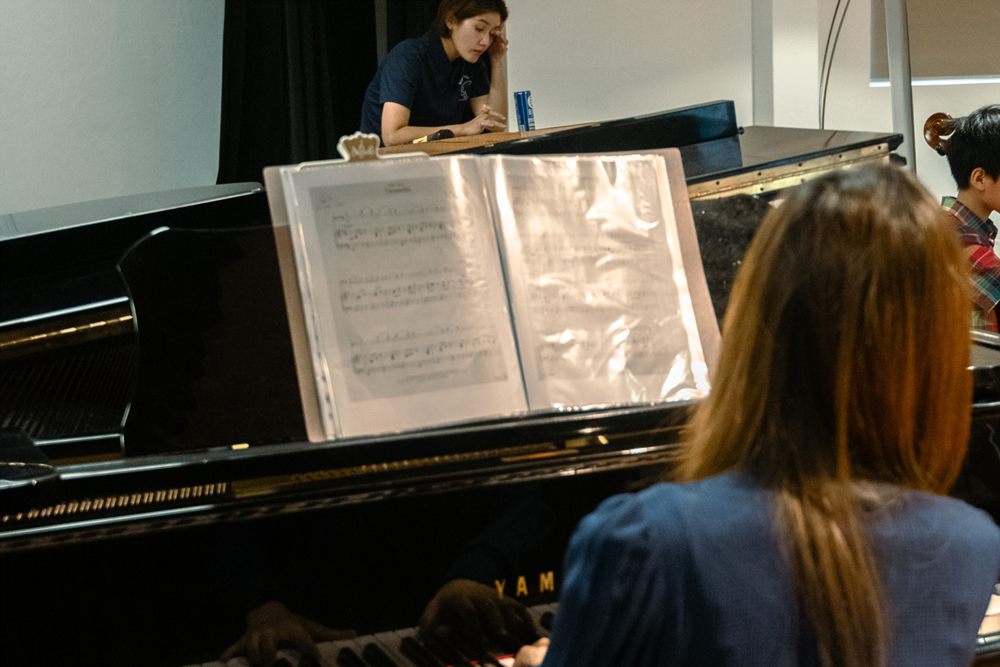 Piano lesson with teacher and student