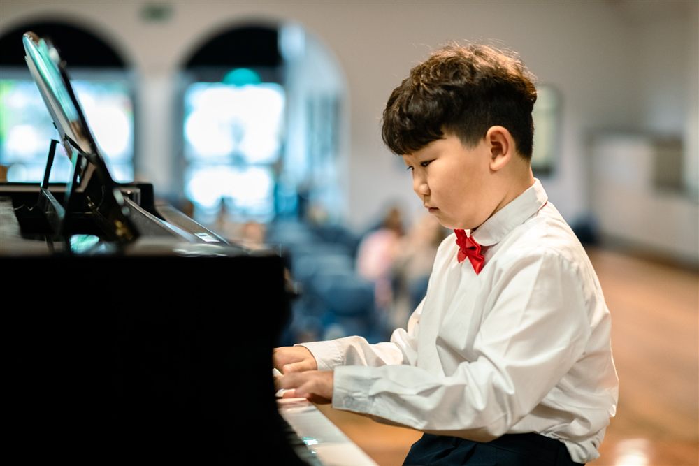 Young student playing piano