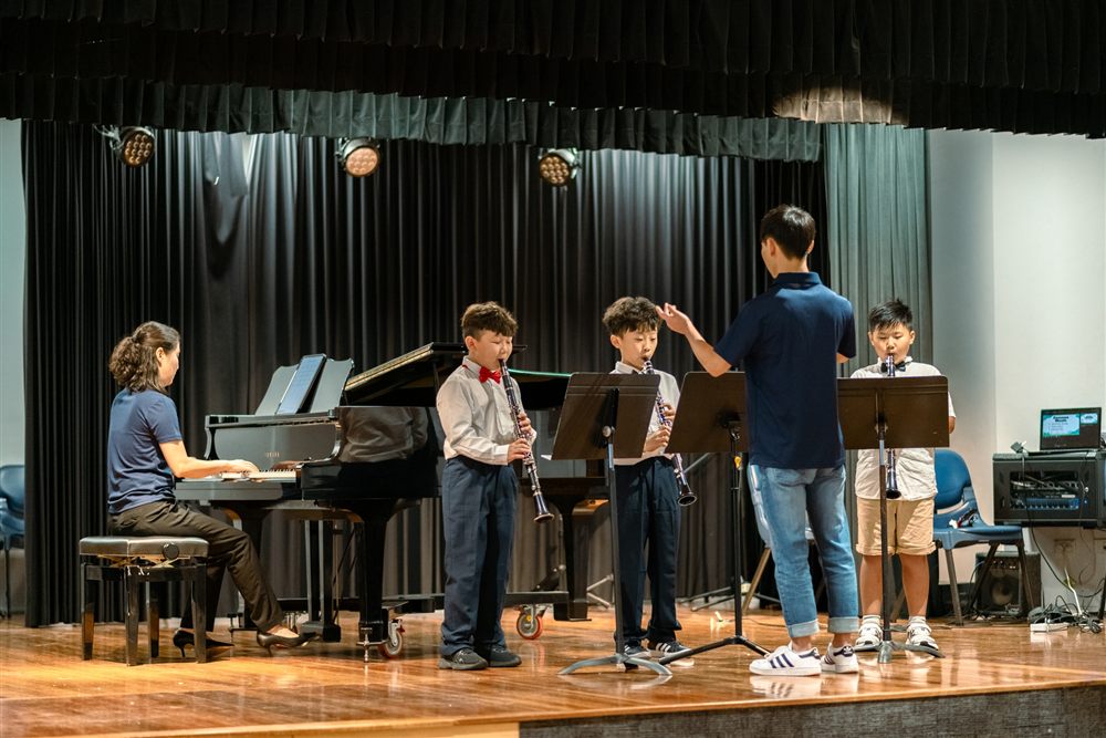 Students performing with piano accompaniment